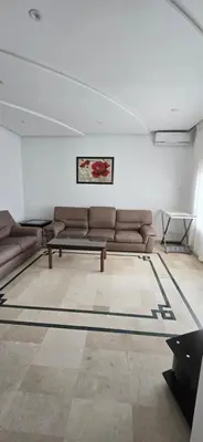 a living room with a couch and a table at Val danfa in Casablanca