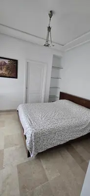 a bedroom with a bed in a white room at Val danfa in Casablanca