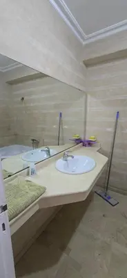 a bathroom with two sinks and a large mirror at Val danfa in Casablanca