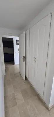 an empty room with white doors and a tile floor at Val danfa in Casablanca