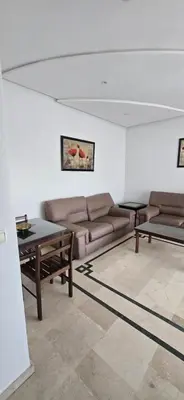 a living room with a couch and a table at Val danfa in Casablanca