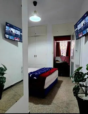 a bedroom with a bed in a room with tv at 16 dreams in Rabat