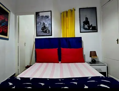 a bedroom with a bed with red and blue at 16 dreams in Rabat