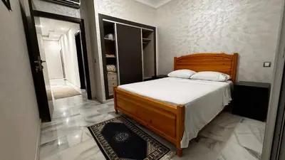 a bedroom with a large bed with white sheets at Cozy apartment Sea view & Comfort in Mohammedia