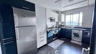a kitchen with a refrigerator and a washing machine at Cozy apartment Sea view & Comfort in Mohammedia