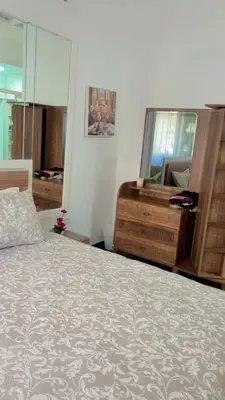 a bedroom with a bed and a dresser and a mirror at Elégance & Confort in Rabat