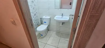 a bathroom with a toilet and a sink at Jolie appartement calme à louer par jour in Bouznika
