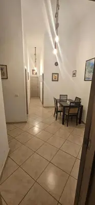 a dining room with a table and two chairs at Jolie appartement calme à louer par jour in Bouznika