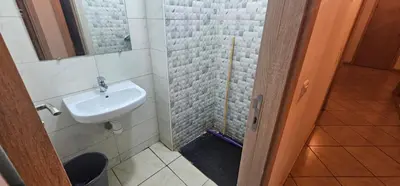 a bathroom with a sink and a mirror at Jolie appartement calme à louer par jour in Bouznika