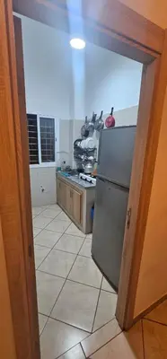 a kitchen with a stainless steel refrigerator and a stove at Jolie appartement calme à louer par jour in Bouznika