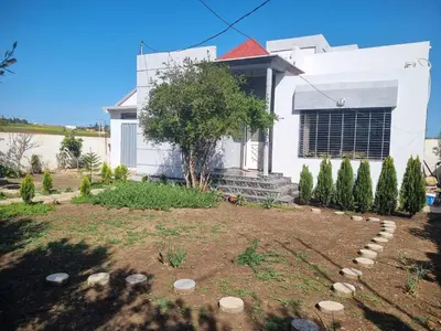 a white house with a garden in front of it at ALTIS Immo Authentic House in Casablanca