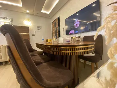 a bar with chairs and a table in a restaurant at Apartement charmante amira in Oulad Kerroum