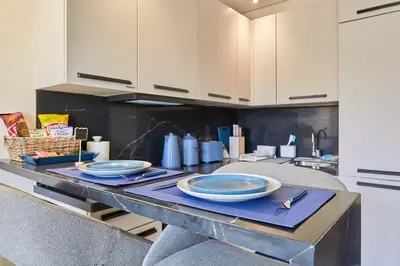 a kitchen with a table with blue plates on it at Blue in Maarif
