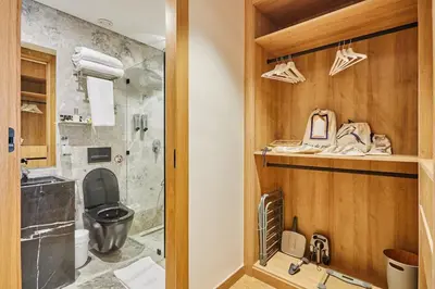 a bathroom with a shower and a toilet and a sink at Blue in Maarif