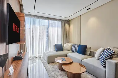 a living room with a couch and a table at Blue in Maarif