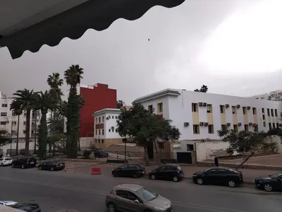 a city street with cars parked in a parking lot at Appartement au centre rabat dyour jamaa in Rabat