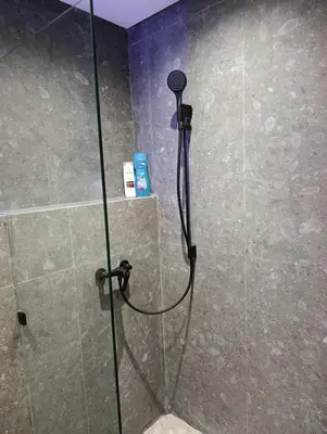 a shower with a glass door in a bathroom at Naturalia Appart & Hotel - Casa Center in Casablanca