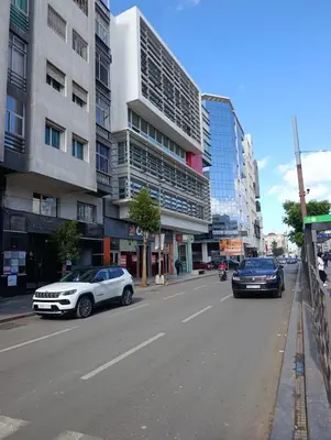 two cars parked on a city street with buildings at Naturalia Appart & Hotel - Casa Center in Casablanca