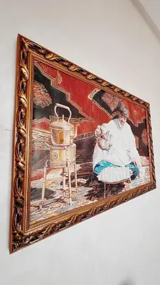 a painting of a woman sitting next to a stove at Superbe 1 chambre avec piscine et jardin, détente garantie, Wi-Fi, balcon et parking in Aïn Harrouda
