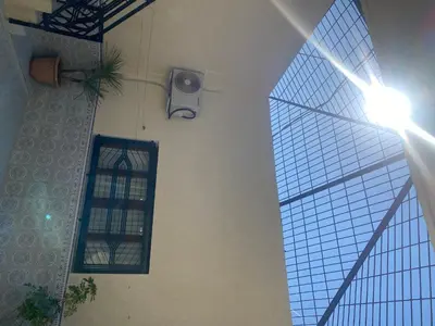 a room with a window and a speaker on a wall at Tradition & Modernité in Rabat