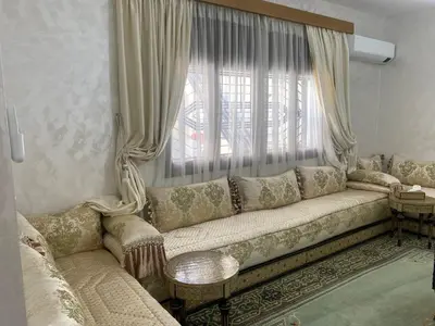 a living room with a couch and a window at Tradition & Modernité in Rabat