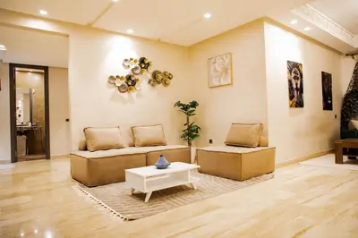 a living room with a couch and a table at Cozy Flat with Gym, fast WiFi and Great Location in Casablanca