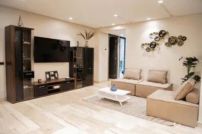 a living room with a couch and a flat screen tv at Cozy Flat with Gym, fast WiFi and Great Location in Casablanca
