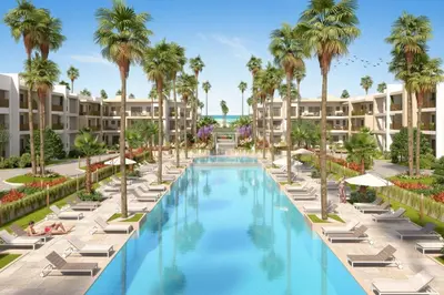 an image of a resort pool with lounge chairs and palm trees at Appartement en bord de mer, Accès Plage & Parking in Mansouria