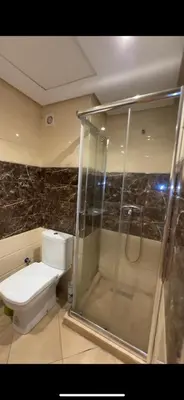 a bathroom with a shower and a toilet and a shower at Appartement de haut standing à EL MANSOURIA residence EBLA in Pont Blondin
