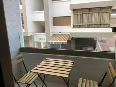 a wooden chair sitting next to a building with a fireplace at Luxury Studio with Pool and Relaxing Atmosphere in O Ben Slimane