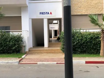 a sign on a pole in front of a building at Luxury Studio with Pool and Relaxing Atmosphere in O Ben Slimane