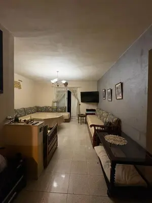 a living room with couches and a couch and a table at Palm Beach in Mansouria