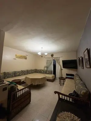 a living room with a couch and a table at Palm Beach in Mansouria