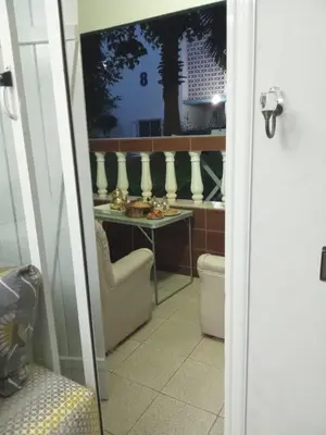 a room with a table and a chair and a table with food at Palm Beach in Mansouria