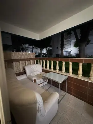 a living room with two white couches and a table at Palm Beach in Mansouria