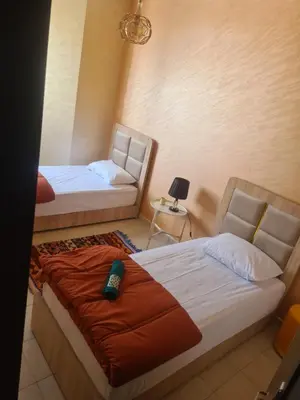 a bedroom with two beds and a couch at Régina AppartHotel in Casablanca