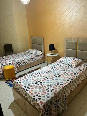 two beds sitting next to each other in a room at Régina AppartHotel in Casablanca
