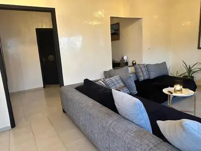 a living room with a couch and a table at Régina AppartHotel in Casablanca