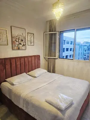 a bedroom with a large bed with a window at CHIC Studio - Appartements proche du Arribat Center AGDAL in Rabat