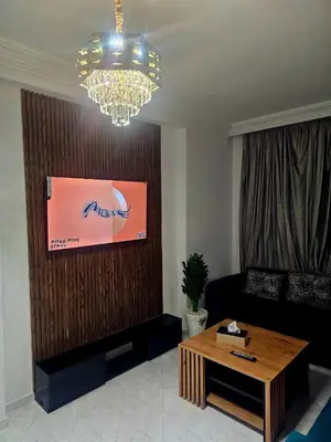 a living room with a couch and a table at CHIC Studio - Appartements proche du Arribat Center AGDAL in Rabat