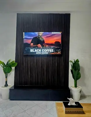 a tv screen with a picture of a black coffee and more at CHIC Studio - Appartements proche du Arribat Center AGDAL in Rabat