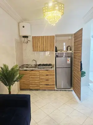 a kitchen with a stainless steel refrigerator and a chandelier at CHIC Studio - Appartements proche du Arribat Center AGDAL in Rabat