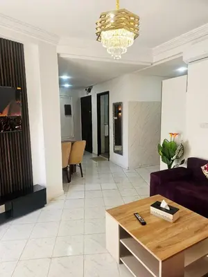 a living room with a couch and a table at CHIC Studio - Appartements proche du Arribat Center AGDAL in Rabat