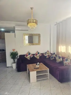 a living room with a couch and a table at CHIC Studio - Appartements proche du Arribat Center AGDAL in Rabat