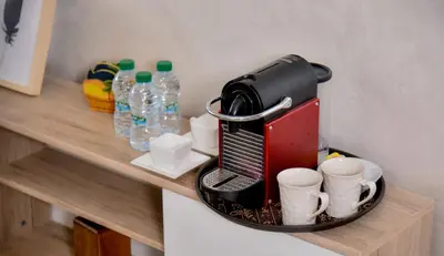 a coffee maker sitting on a shelf with cups at Atlantic View in Casablanca