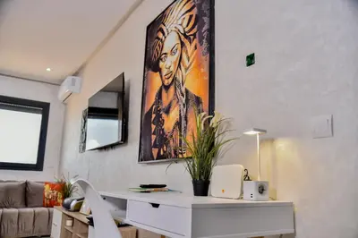 a living room with a desk and a painting on the wall at Atlantic View in Casablanca