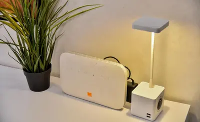 a modem and a lamp on a table with a plant at Atlantic View in Casablanca