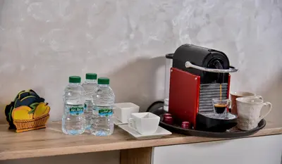 a counter with two bottles of water and a coffee maker at Atlantic View in Casablanca