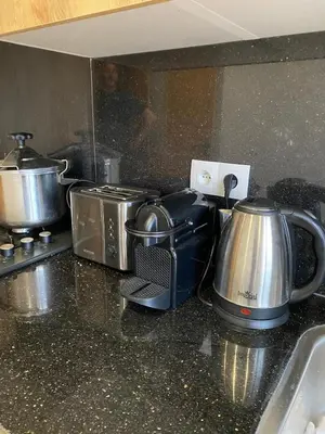 a kitchen counter top with a toaster and a tea kettle at Sidi Rahal beach apartment Heaven beach in Sidi Rahal