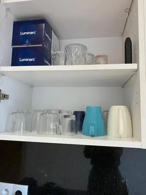 a shelf with glasses and other items on it at Sidi Rahal beach apartment Heaven beach in Sidi Rahal